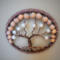 Brown polyester yarn frames 3in metal hoop. brown wire is twisted to create a tree of life. wood and faux pearl beads
